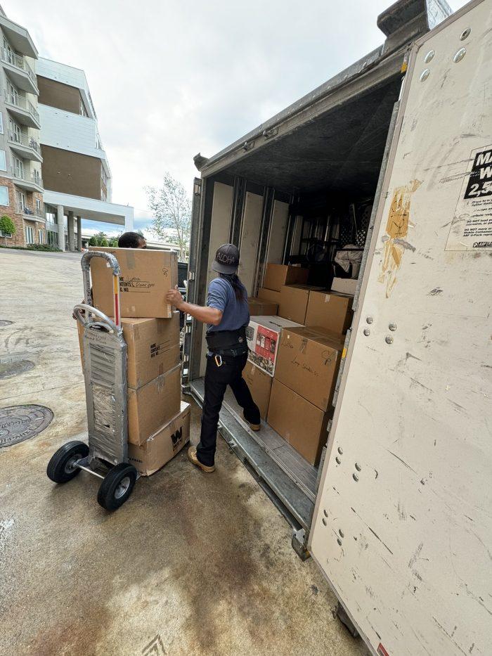 Movers loading U-Pack container