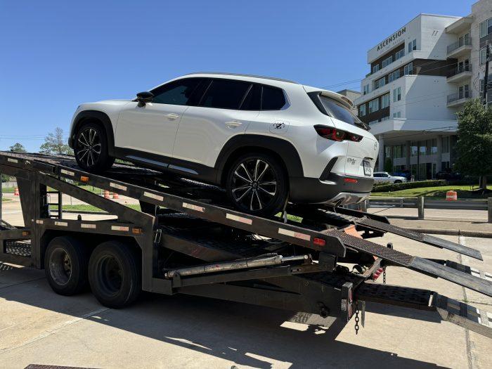 Car loaded onto trailer for transport